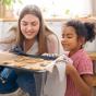 Babysitter sort des pâtisseries du four avec une fillette